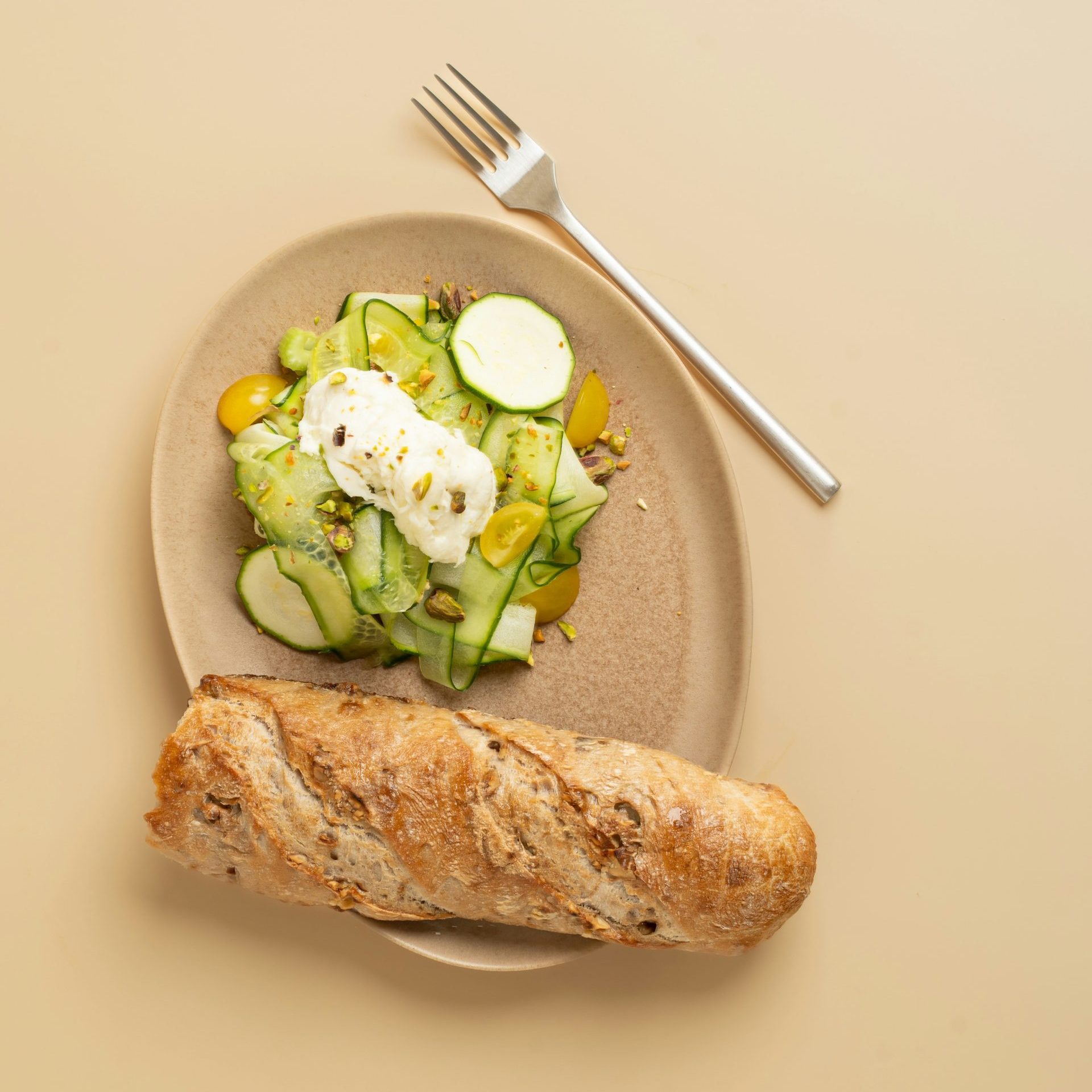A plate with a sandwich and a salad on it